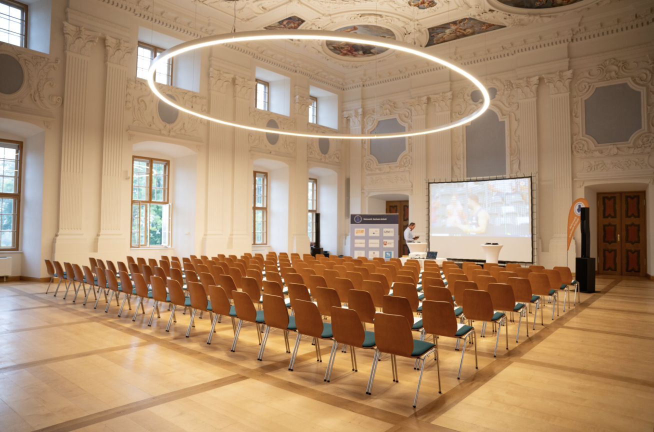 Festsaal Schloss Hundisburg mit Stuhlreihen und Netzwerk Sachsen-Anhalt Leinwand